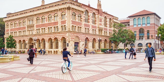 Students walk and cycle on the campus of the University of Southern California, Los Angeles.