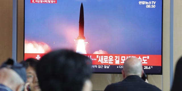People watch a TV showing a file image of a North Korea's missile launch during a news program at the Seoul Railway Station in Seoul, South Korea, Tuesday, Aug. 6, 2019.