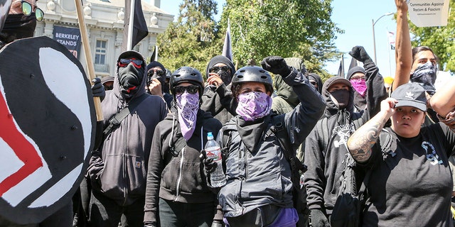 Antifa members and counter protesters gather during a rightwing No-To-Marxism rally on August 27, 2017 at Martin Luther King Jr. Park in Berkeley, California. / AFP PHOTO / Amy Osborne (Photo credit should read AMY OSBORNE/AFP/Getty Images)