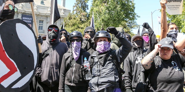 Antifa members and counter protesters gather during a rightwing No-To-Marxism rally on August 27, 2017 at Martin Luther King Jr. Park in Berkeley, California. / AFP PHOTO / Amy Osborne (Photo credit should read AMY OSBORNE/AFP/Getty Images)