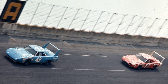 Richard Petty leads Bobby Isaac during the 1970 Firecracker 400 NASCAR Cup race at Daytona International Speedway.