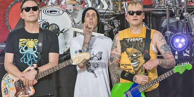 Mark Hoppus, Travis Barker and Matt Skiba perform as Blink 182 on "Good Morning America" in 2019. Hoppus traveled to Italy for Barker's wedding to Kourtney Kardashian on Sunday.