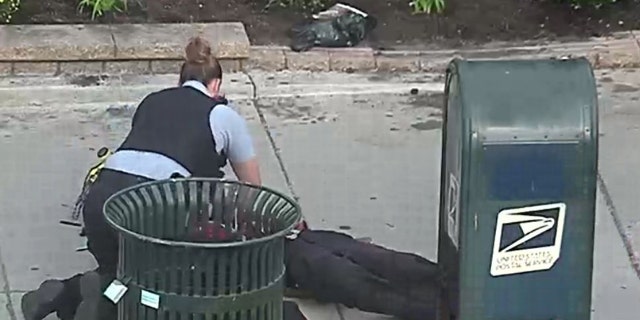 The unidentified female officer with the 18th District began performing chest compressions on an "unresponsive" male victim.