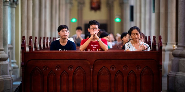 Catholic worshippers attend a mass at the government-sanctioned St. Ignatius Catholic Cathedral in Shanghai Sept. 30, 2018. 