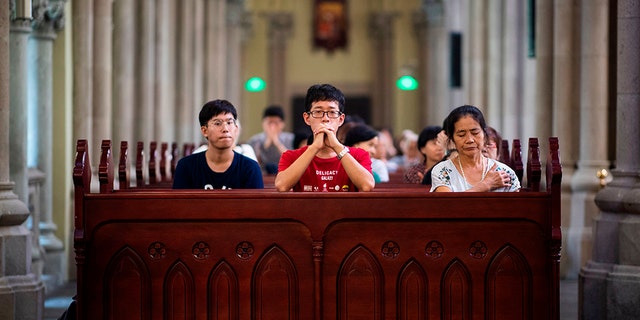 Catholic worshippers attend a mass at the government-sanctioned St. Ignatius Catholic Cathedral in Shanghai Sept. 30, 2018.