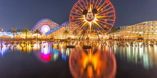 Anaheim, CA USA - August 22, 2015: Disneyland 60th aniversary at Cars Land. This year Disneyland celebrates its 60th aniversary of been open. On this day the park celebrated with fireworks and over 150 thousand people. People walk around rides and games at the downtown Cars Land during the night time. (iStock)