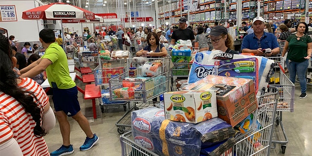 Shoppers wait in long lines at Costco, Thursday, in Davie, Fla., as they stock up on supplies ahead of Hurricane Dorian. (AP)