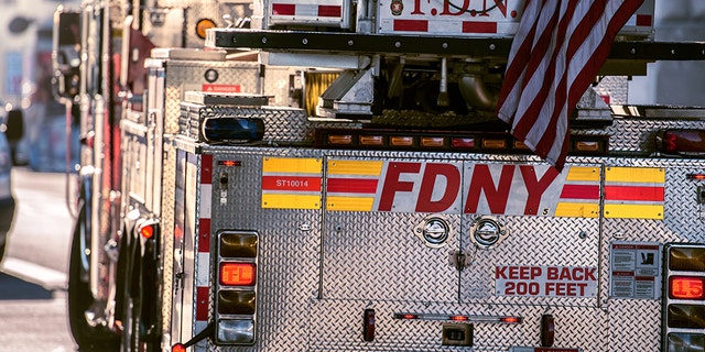 A Fire Department of New York Ladder truck going for rescue with firemen.