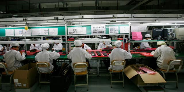 Workers are seen inside a Foxconn factory in Longhua, in China's Guangdong province.