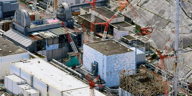 FILE - This Sept. 4, 2017, aerial file photo shows Fukushima Dai-ichi nuclear power plant reactors, bottom from right, Unit 1, Unit 2 and Unit 3, in Okuma town, Fukushima prefecture, northeastern Japan. The utility company operating Fukushima's tsunami-wrecked nuclear power plant said Friday, Aug. 9, 2019 it will run out of space for tanks to store massive amounts of treated but still contaminated water in three years, adding pressure for the government and the public to reach consensus on what to do with the water. (Daisuke Suzuki/Kyodo News via AP, File)