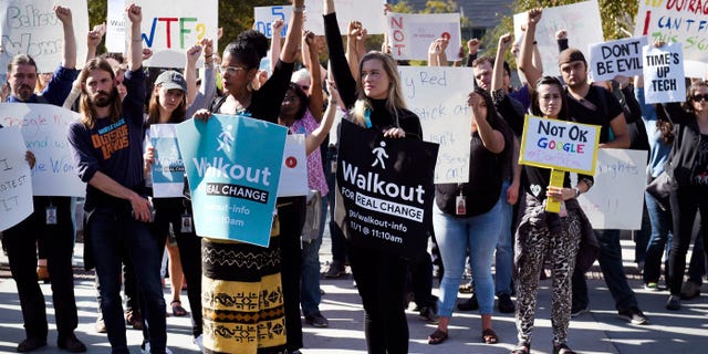 Google employees hold signs during a walkout to protest how the tech giant handled sexual misconduct in Mountain View, California, U.S., on Thursday, Nov. 1, 2018.