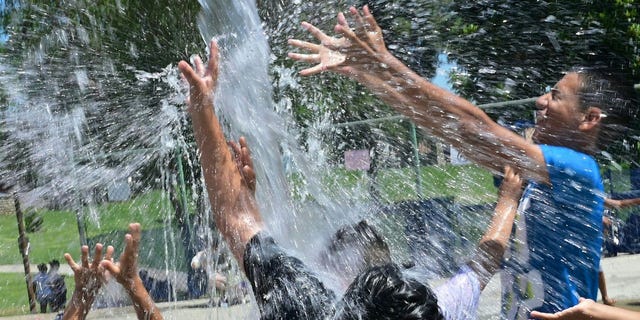 Children cool off in a water park in Alhambra, California, during a heat wave reaching three-digit temperatures.