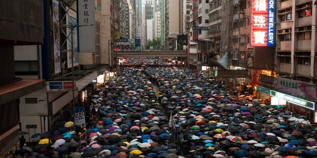 Protesters impetus while holding umbrellas during a demonstration. Over 1 million Hong Kongese protesters filled a streets of Hong Kong Island to criticism opposite military brutality, a extradition bill, and other grievances notwithstanding a consistent complicated downpour.