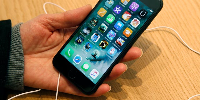 A patron checks an iPhone 7 in Paris, France.