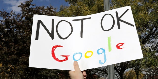 A Google employee holds a sign during a walkout to protest how the tech giant handled sexual misconduct at Jackson Square Park in New York, U.S., Thursday, Nov. 1, 2018.