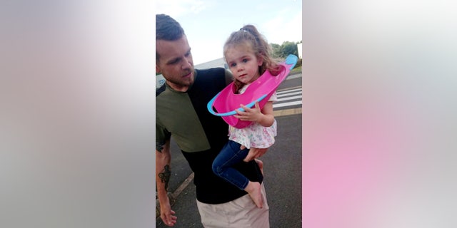 "I thought it would just come off but her ears kept getting in the way and she was getting so mad at me," her father said. (SWNS)