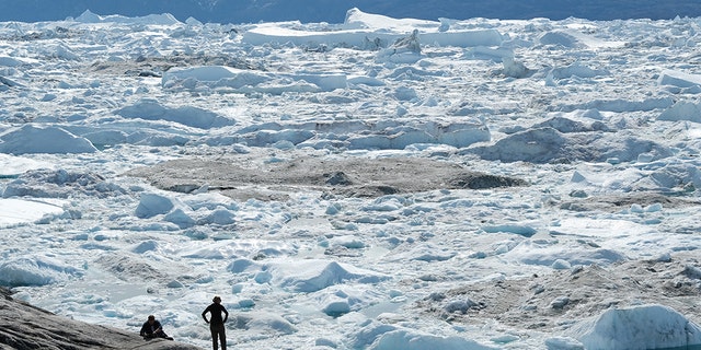 File photo: Visitors look out onto free-floating ice jammed into the Ilulissat Icefjord during unseasonably warm weather on July 30, 2019 near Ilulissat, Greenland. The Sahara heat wave that recently sent temperatures to record levels in parts of Europe is arriving in Greenland.  (Photo by Sean Gallup/Getty Images)