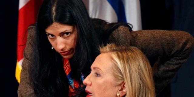 Secretary of State Hillary Clinton talking with her deputy chief of staff, Huma Abedin, in 2011.