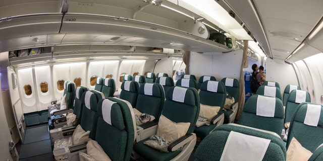 An interior shot of a Cathay Pacific Airbus A330-300, premium economy class cabin.
