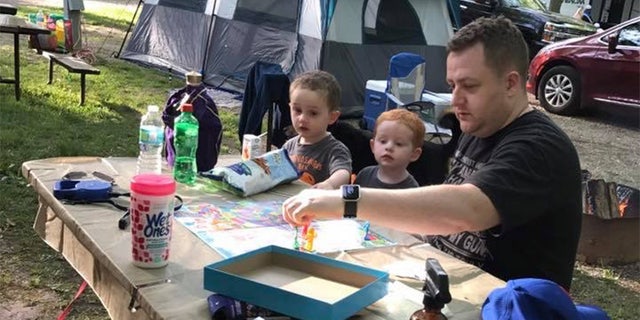 Becki Keltner says Jacob "loved his family above everything" and "cared about everyone." He is pictured here playing a board game with his two children, Caleb, far left, and Carson, center.