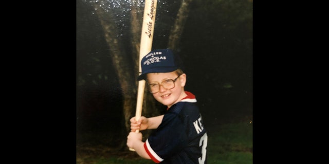 Jacob Keltner, shown here as a boy, played in Little League. Becki tells Fox News that the weekend before Jacob died, he took Caleb to a baseball clinic in preparation for his son’s first Little League season and took him out shopping for gear afterward. Jacob purchased Caleb a Chicago Cubs hat and he continues to wear it ‘all the time,’ Becki says. She has attended all of Caleb’s practices and games this season, but she says opening day was ‘so hard for me’ as her son ‘should have been able to have his dad there.’ A loving father, she added, who ‘wanted to be there and help his son.’