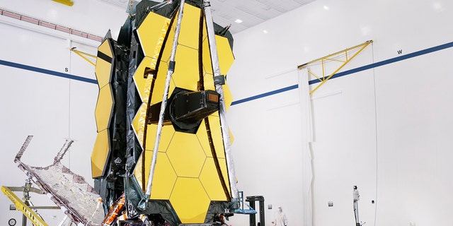 The fully assembled James Webb Space Telescope, with its sunshield and unitized pallet structures that fold up around the telescope for launch, partially deployed to an open configuration to enable telescope installation. (Credit: NASA/Chris Gunn)