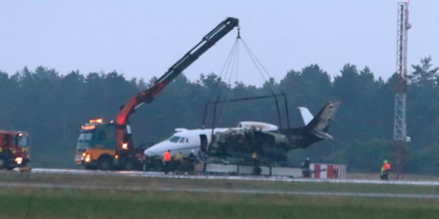 A private aircraft is recovered after it caught fire on landing at Aarhus Airport in Tirstrup, Denmark, Tuesday, Aug. 6, 2019.