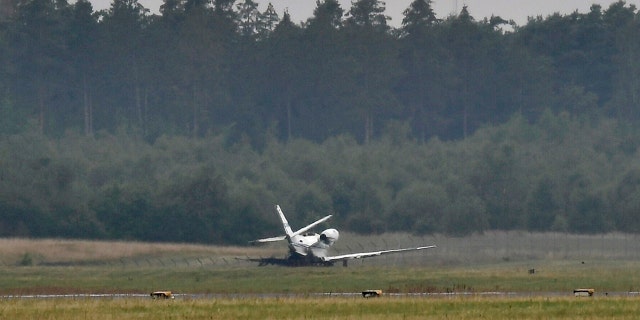 A private aircraft lays off the runway after it caught fire on landing at Aarhus Airport in Tirstrup, Denmark, Tuesday, Aug. 6, 2019.