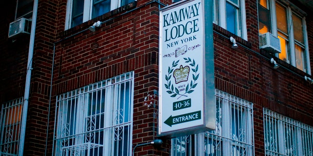 A sign points to the entrance of the Kamway Lodge Thursday, Aug. 22, 2019, in the Queens borough of New York. Police say the body of Andrea Zamperoni, a chef at a popular restaurant in New York's Grand Central Terminal who went missing the previous weekend, was found at the hostel earlier in the day. (AP Photo/Eduardo Munoz Alvarez)