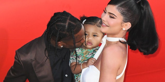 Kylie Jenner — seen here with Stormi and Stori's dad Travis Scott, whom Jenner recently split with — is now selling sweathirts inspired by her viral "rise and shine" moment.