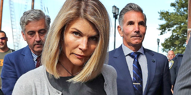 Lori Loughlin and her husband Mossimo Giannulli leave the John Joseph Moakley courthouse in Boston on August 27, 2019. Giannulli, 57, is currently serving his five-month prison sentence in Lompoc, California.