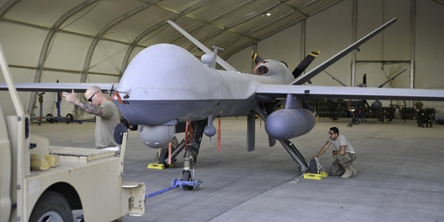 Maintainers from the 386th Expeditionary Aircraft Maintenance Squadron prepare to tow an MQ-9 Reaper unmanned aerial vehicle into position for an engine test before Intelligence, Surveillance and Reconnaissance (ISR) operations at Ali Al Salem Air Base, Kuwait, July 23, 2019. (U.S. Air Force Photo by Staff Sgt. Mozer O. Da Cunha)