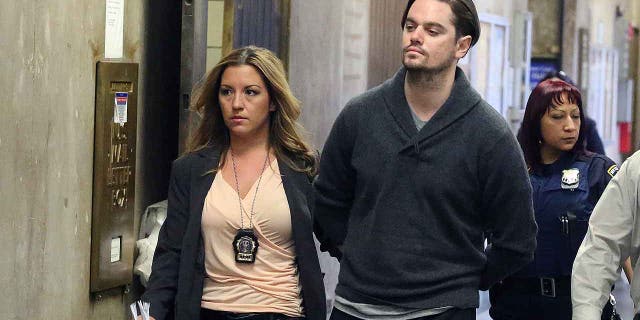 Nicholas Brooks is led into Manhattan Criminal Court on Monday, May 6, 2013. Brooks, already in jail awaiting trial for allegedly killing swimsuit designer Sylvie Cachay, was rearrested and charged with impersonation a Corrections officer when he made a call from jail.