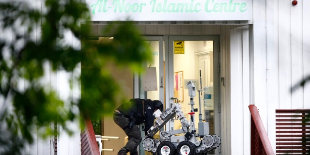 Police attend the scene after a shooting inside the al-Noor Islamic center mosque in Baerum outside Oslo.