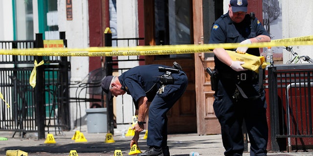 Authorities retrieve evidence markers at the scene of a mass shooting in Dayton, Ohio.