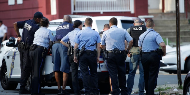 Philadelphia police stage as they respond to an active shooting situation, Wednesday, Aug. 14, 2019, in the Nicetown neighborhood of Philadelphia.
