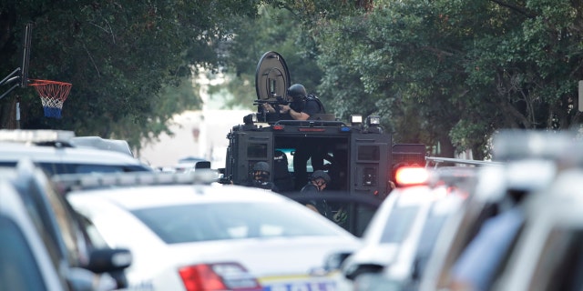 Authorities stand outside a house as they investigate an active shooting situation, Wednesday, Aug. 14, 2019, in the Nicetown neighborhood of Philadelphia. (Associated Press)