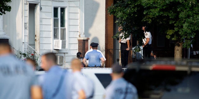 Police standing outside a house as they investigated the active shooting situation.