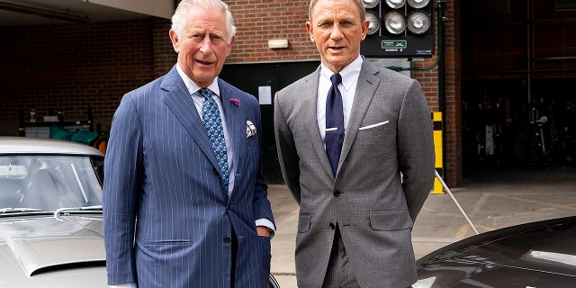 Prince Charles, Prince of Wales poses with British actor Daniel Craig as he tours the set of the 25th James Bond Film at Pinewood Studios on June 20, 2019 in Iver Heath, England.