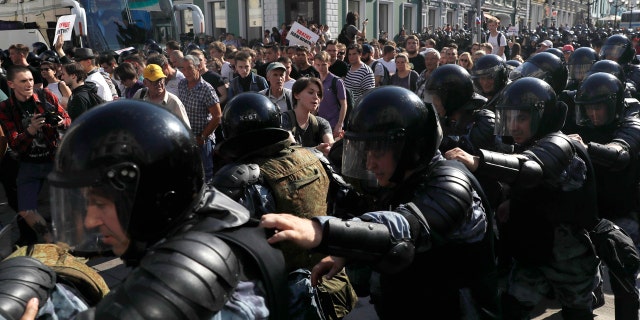 In this file photo dated Saturday, July 27, 2019, police block a street during an unsanctioned rally in the center of Moscow, Russia.