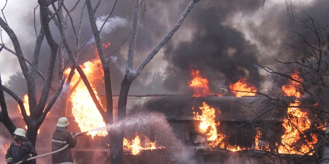 Firefighters try to extinguish the petrol tanker blaze Saturday in Morogoro, Tanzania. (AP Photo)