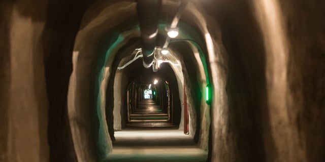 DARPA asked for information about underground dens in a recent tweet. The picture above shows the interior of the Barbara Tunnel in Oberried, Germany. The tunnel is the long - term central archive of Germany since 1975.