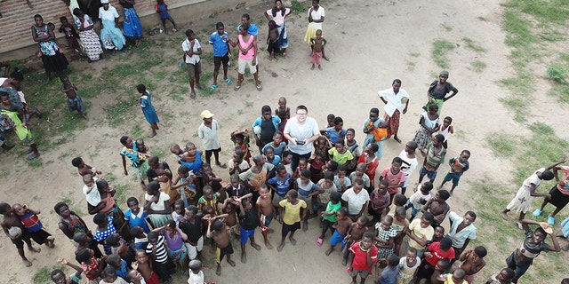 Crowd watches UNICEF Malawi’s Drone Co-ordinator Tautvydas Juskauskas testing a drone