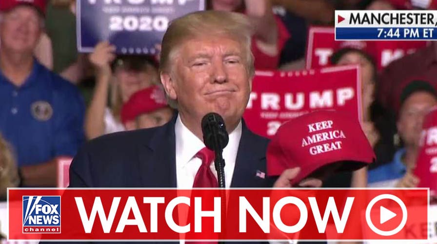 Watch Trump shows off red cap with updated campaign slogan during