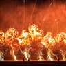 Technicians stand in front of exploding pyrotechnics during an international air show in Bucharest, Romania, Aug. 24, 2019. 
