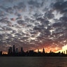 The sun rises behind the skyline of midtown Manhattan, in New York City, Aug. 24, 2019.