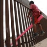 A child plays seesaw installed between the border fence that divides Mexico from the United States in Ciudad de Juarez, Mexico, July 28, 2019. 