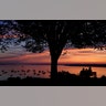 An early-rising couple is rewarded with a colorful sunrise over Casco Bay, in Portland, Maine, Aug. 21, 2019. 