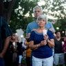 Susan Meyers and husband Michael Oshan listen to a hymn during a vigil for victims of a shooting that left three people dead at the Gilroy Garlic Festival, in Gilroy, California, July 29, 2019.
