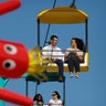 Democratic presidential candidate South Bend Mayor Pete Buttigieg rides the sky glider at the Iowa State Fair, in Des Moines, Iowa, Aug. 13, 2019. 